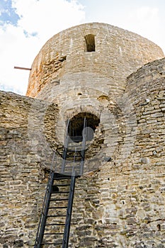 Izborsk, Russia, September 7, 2023. Entrance to a watchtower with a metal staircase.