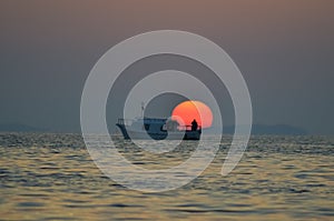 Izmir aliaga yenisakran bay fishermans in the boat and sun