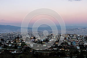 Izmir city view. Pink sky and mountains above city