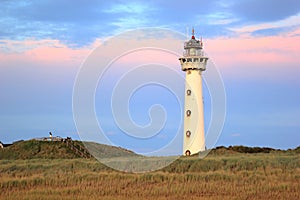 Lighthouse at sunset in the twilight. Egmond aan Zee, North Sea, the Netherlands.