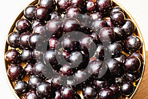 Jabuticaba fruit with textured background.