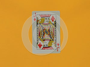 A Jack of Diamonds playing card on a yellow background.