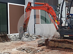 Jack hammer tracked bulldozer breaking concrete