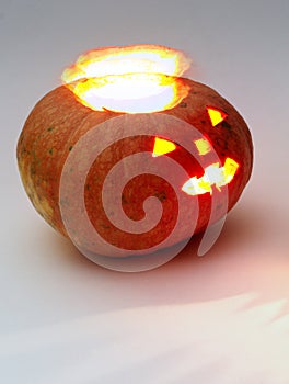 Jack o lantern. halo-like glow separates from entrails. Orange round pumpkin with lantern inside and glows