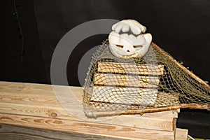 Jack O`Lantern. A pumpkin with burning eyes. A pumpkin for Halloween on an old wooden table against the background of old books.