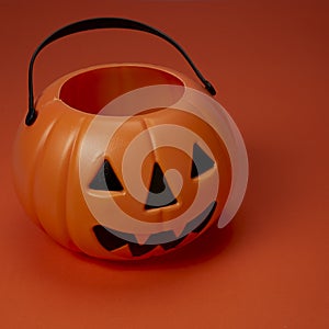 Jack o lantern pumpkin on orange background