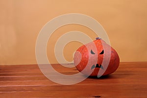 Jack O Lantern on wooden table against yellow background. Halloween concept photo