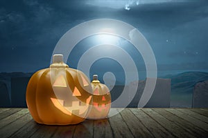 Jack-o-Lantern on the wooden table with graveyard