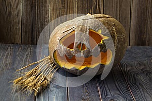 Jack o lanterns Halloween pumpkin face on wooden background