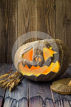 Jack o lanterns Halloween pumpkin face on wooden background