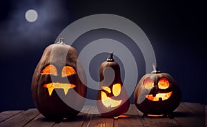 Jack o lanterns Halloween pumpkin face on wooden background