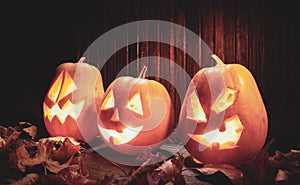 Jack o lanterns  Halloween pumpkin face on wooden background