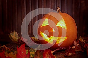 Jack o lanterns Halloween pumpkin face on wooden background