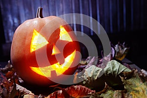 Jack o lanterns Halloween pumpkin face on wooden background