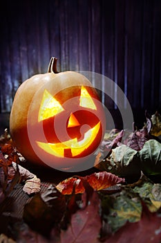 Jack o lanterns Halloween pumpkin face on wooden background