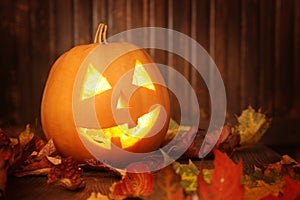 Jack o lanterns Halloween pumpkin face on wooden background