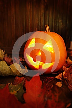 Jack o lanterns Halloween pumpkin face on wooden background