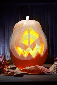 Jack o lanterns Halloween pumpkin face on wooden background