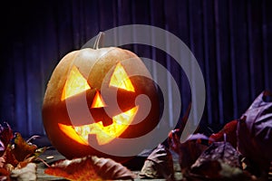 Jack o lanterns Halloween pumpkin face on wooden background