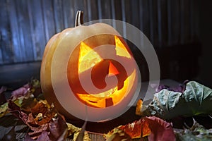 Jack o lanterns Halloween pumpkin face on wooden background