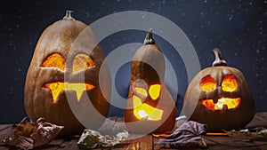 Jack o lanterns Halloween pumpkin face on wooden background