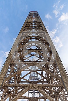 Jack up oil rig leg with blue sky when almost fully up