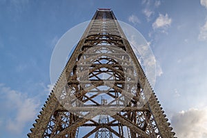 Jack up oil rig leg with blue sky when almost fully up