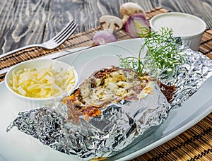 Jacket Potato with onion and mushroom served in dish isolated on grey background top view of bahrain food