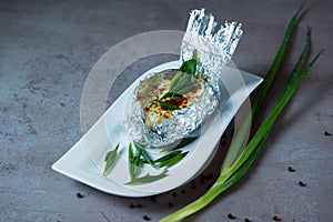 Jacket Potato with onion and mushroom served in dish isolated on grey background top view of bahrain food