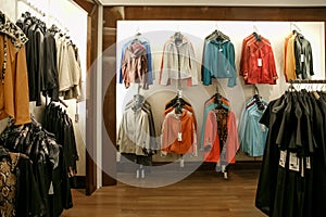 Jackets and coat hang on a hanger in a store.