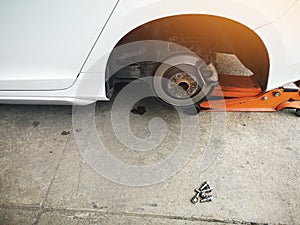 jacking up a car with the emergency jack for changing car tire