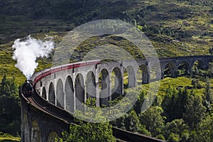 Jacobite steam train on Glenfinnan Viaduct at Loch Shiel, Mallaig, Highlands, Scotland photo