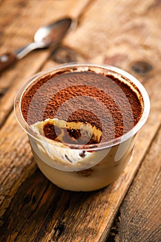 Jacopo Tiramisu Mousse served in jar isolated on wooden table top view of arabic sweet dessert photo