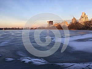 Jacqueline Kennedy Onassis Reservoir with Frozen Water during Sunset in Winter in Central Park in Manhattan, New York, NY.