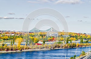 Jacques-Cartier Bridge in Montreal, in automn with the Biodome in foreground photo