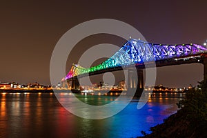 Jacques Cartier Bridge in a rainbow lighting at night. Montreal