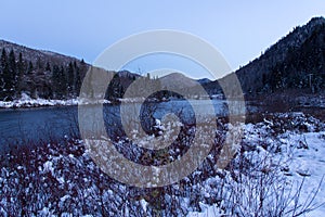 The Jacques-Cartier river flowing through the Jacques-Cartier National Park valley seen during a late Fall blue hour