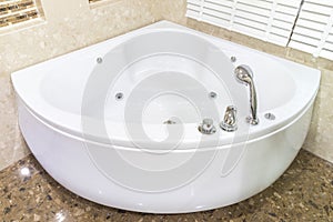 Jacuzzi in corner of bathroom