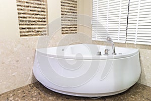 Jacuzzi in corner of bathroom