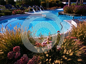 Jacuzzi and pool with thermal water surrounded by flowers