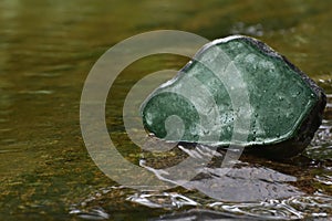 Jade Green jade A lump placed on the water in the forest is a beautiful nature photo