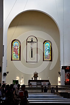 Interior pews and altar with worshippers of St Mary`s Cathedral Catholic church Jaffna Sri Lanka