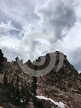 Jagged cliff in Little Cottowood Canyon Utah with dark gloomy skies