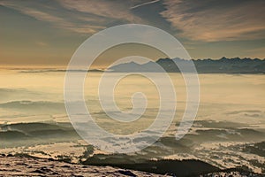 Jagged High Tatra peaks above sea of fog at sunrise in Poland