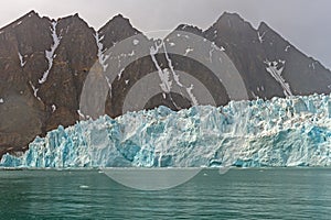 Jagged Mountains Behind a Jagged Glacier