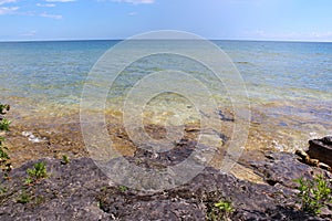 The jagged, rocky shoreline of Lake Michigan in the summer in Cave Point County Park, Wisconsin