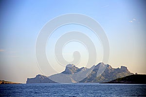 Jagged rocky wall silhouette on azure sea, at sunset, Parc National des Calanques, Marseille, France