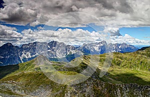 Jagged Sexten Dolomites with green slopes of Carnic Alps Italy