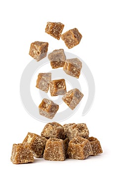 Jaggery falling on white background