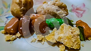Jaggery,Toffee And Basil Leaves Lying In The Plastic Plate. Hindu Lord Offering `Prasadam`.